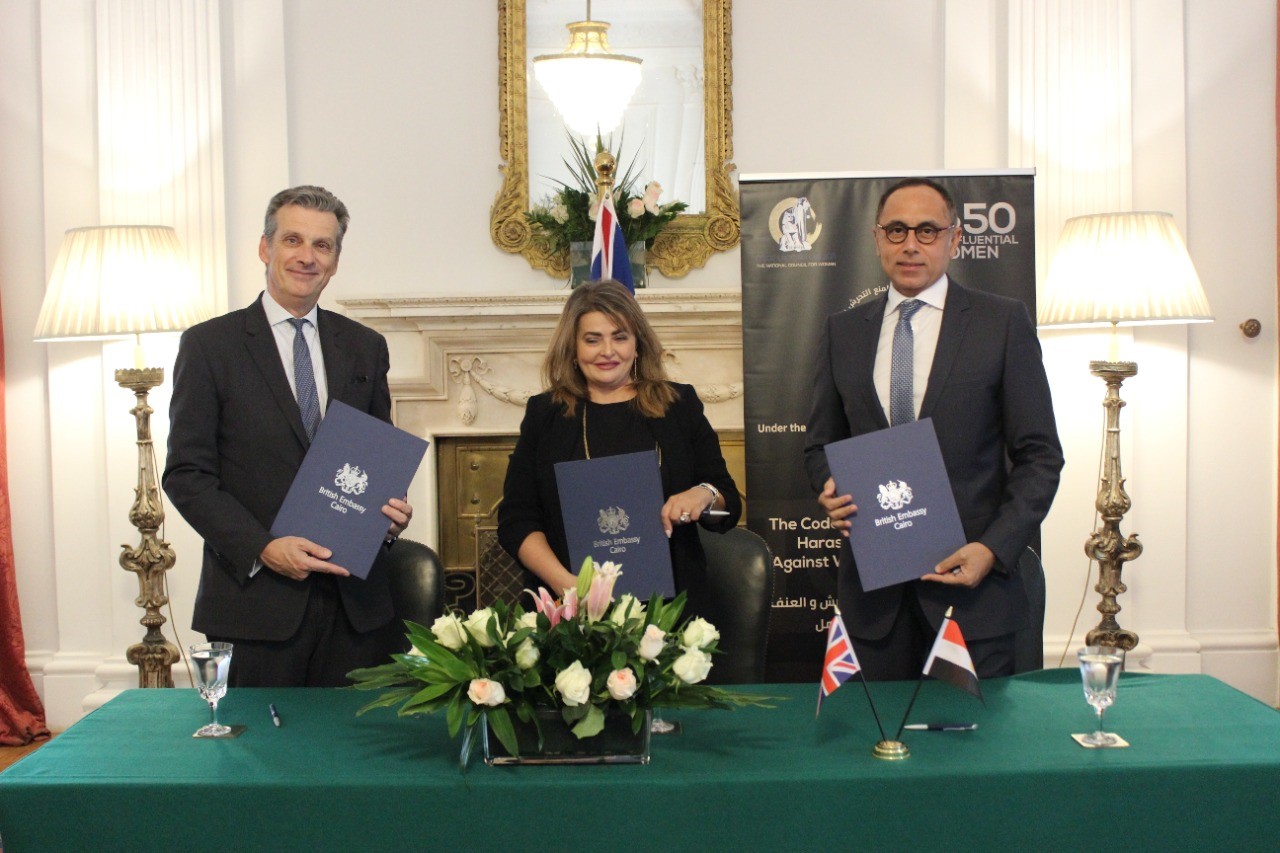 Sir Geoffrey Adams, UK Ambassador to Egypt; Khaled Nosseir, chairman of the British Egyptian Business Association (BEBA); and Dina Abdel Fattah – President of the Top 50 Women Forum, sign the code of ethics for combating sexual harassment and all forms of violence against women in the workplace at the British embassy to Egypt on Sunday, June 27, 2021.