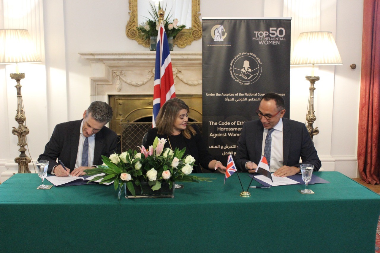 Sir Geoffrey Adams, UK Ambassador to Egypt; Khaled Nosseir, chairman of the British Egyptian Business Association (BEBA); and Dina Abdel Fattah – President of the Top 50 Women Forum, sign the code of ethics for combating sexual harassment and all forms of violence against women in the workplace at the British embassy to Egypt on Sunday, June 27, 2021. 