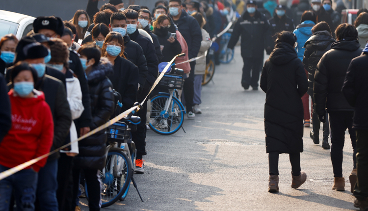 A line of people in China wearing masks following the outbreak of Corona pandemic