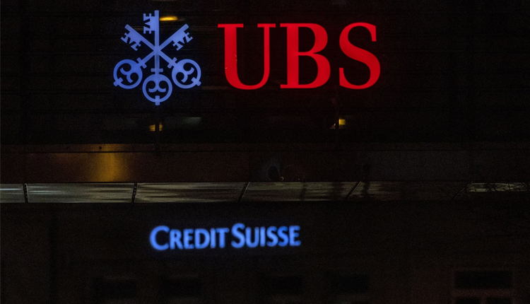 Logos of Swiss banks UBS and Credit Suisse are seen on an office building in Zurich, Switzerland March 19, 2023