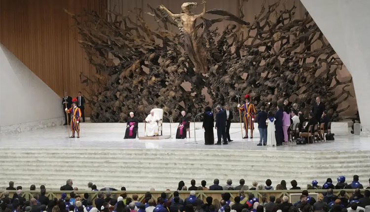 Crowd the Paul VI hall as Pope Francis meets with refugee families at the Vatican, Saturday, March 18, 2023