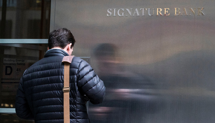 A worker arrives to the Signature Bank headquarters in New York City, U.S., March 12, 2023.