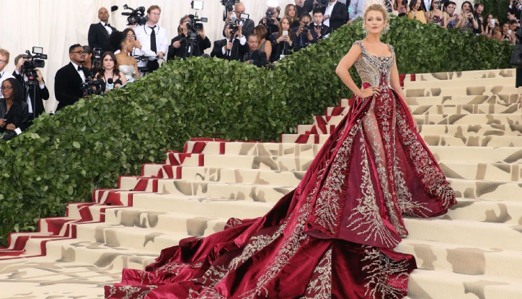 Blake Lively during 2018 Met Gala in a crimson Versace gown with embroidered bodice