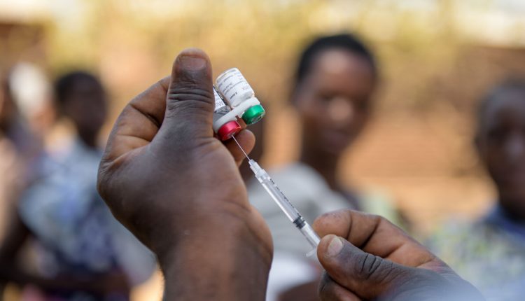 A person giving the malaria vaccine