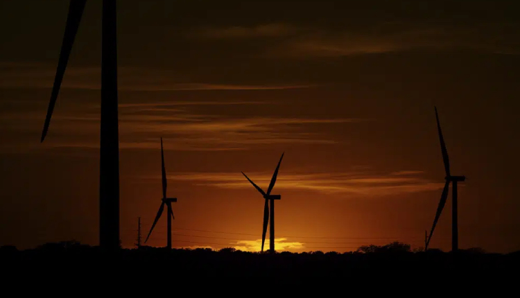 Wind turbines are seen at sunset on a wind farm near Del Rio, Texas
