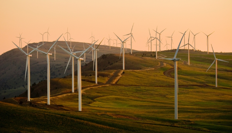 Sight of wind turbines over a hill