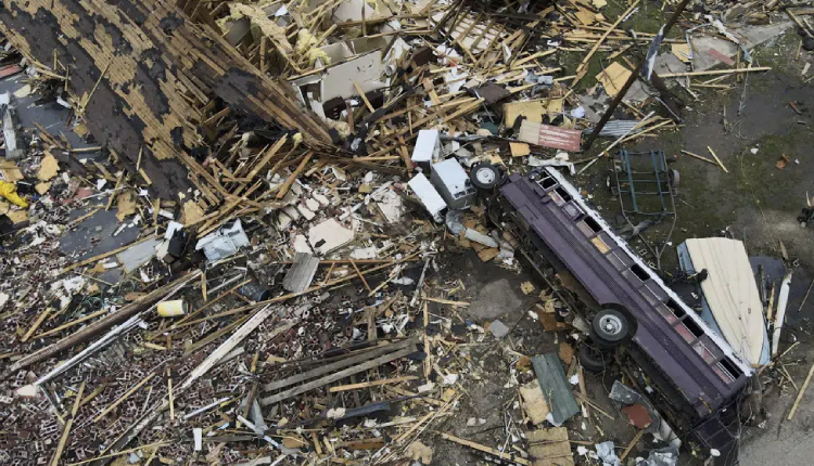 Debris is strewn about tornado-damaged homes March 26, 2023, in Rolling Fork, Miss